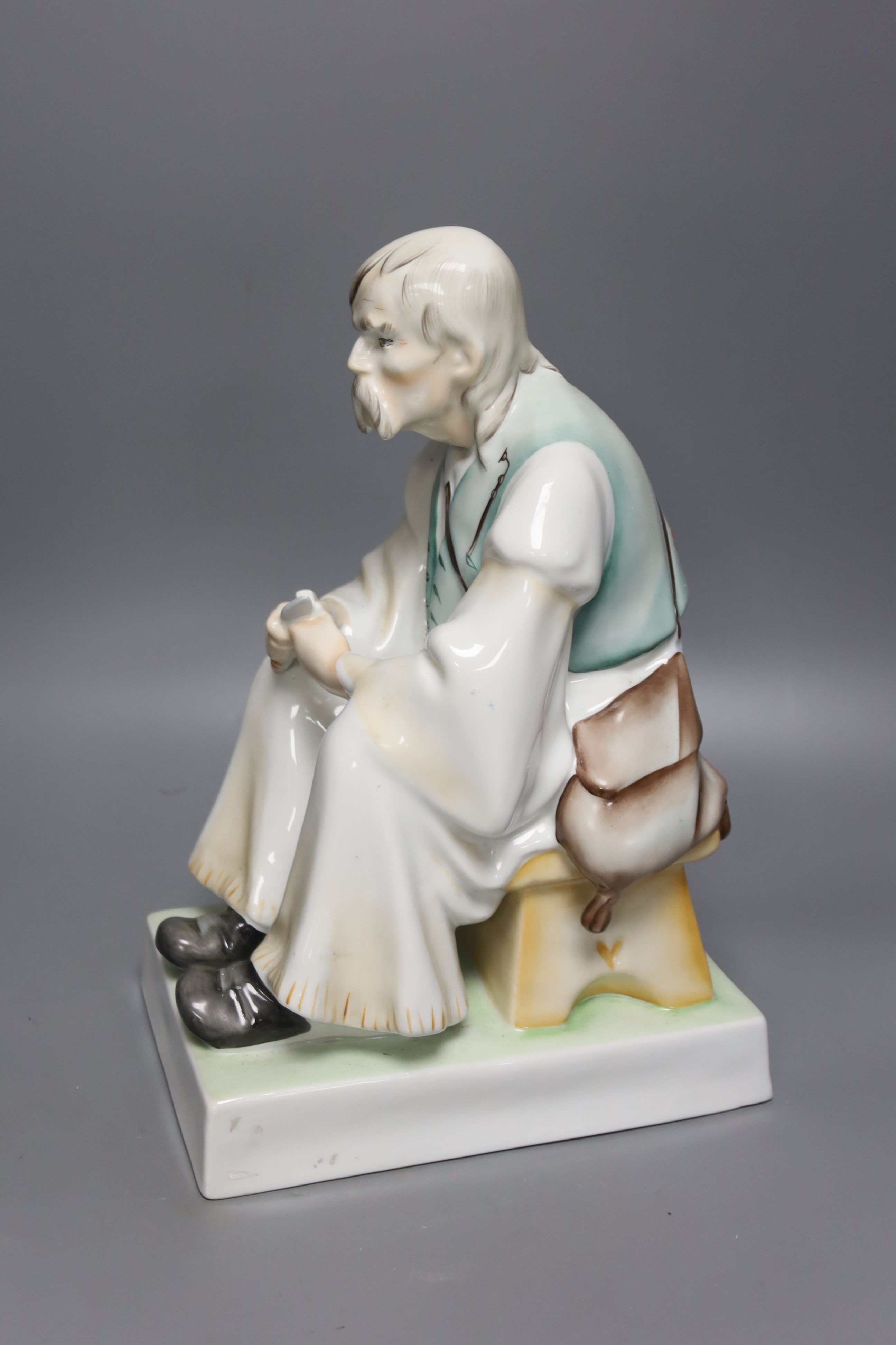 A Zsolnay porcelain figure of a seated peasant, height 33cm